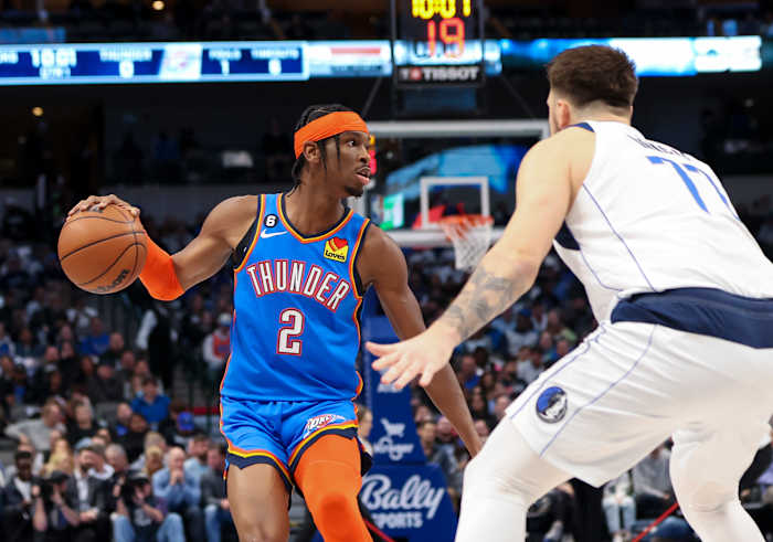 Dec 12, 2022; Dallas, Texas, USA; Oklahoma City Thunder guard Shai Gilgeous-Alexander (2) dribbles as Dallas Mavericks guard Luka Doncic (77) defends during the first quarter at American Airlines Center. Mandatory Credit: Kevin Jairaj-USA TODAY Sports